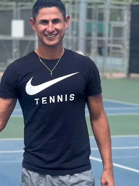 Jhon, coach at Racket Club, on court