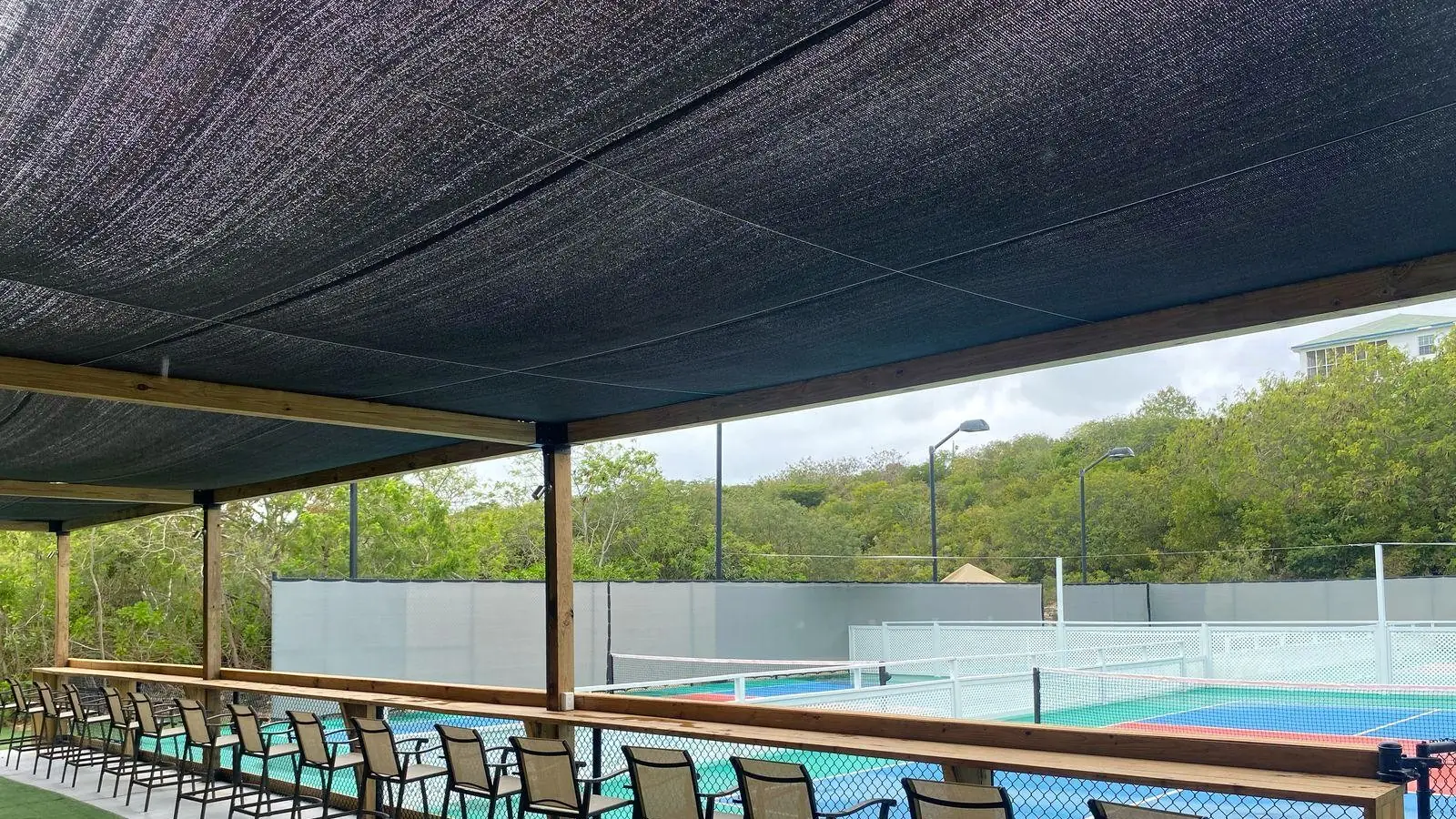 Covered terrace at Racket Club overlooking the pickleball courts in Providenciales