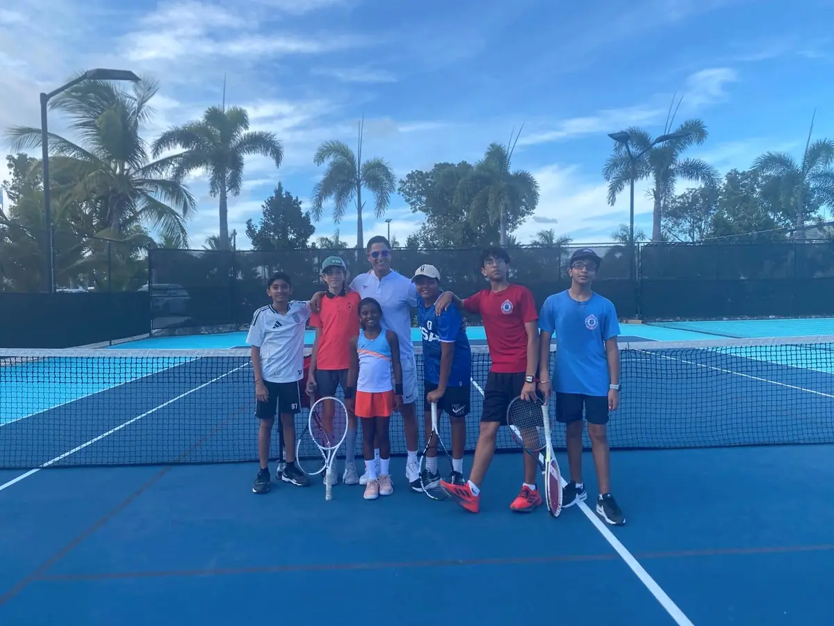 Junior academy players with their coaches on court