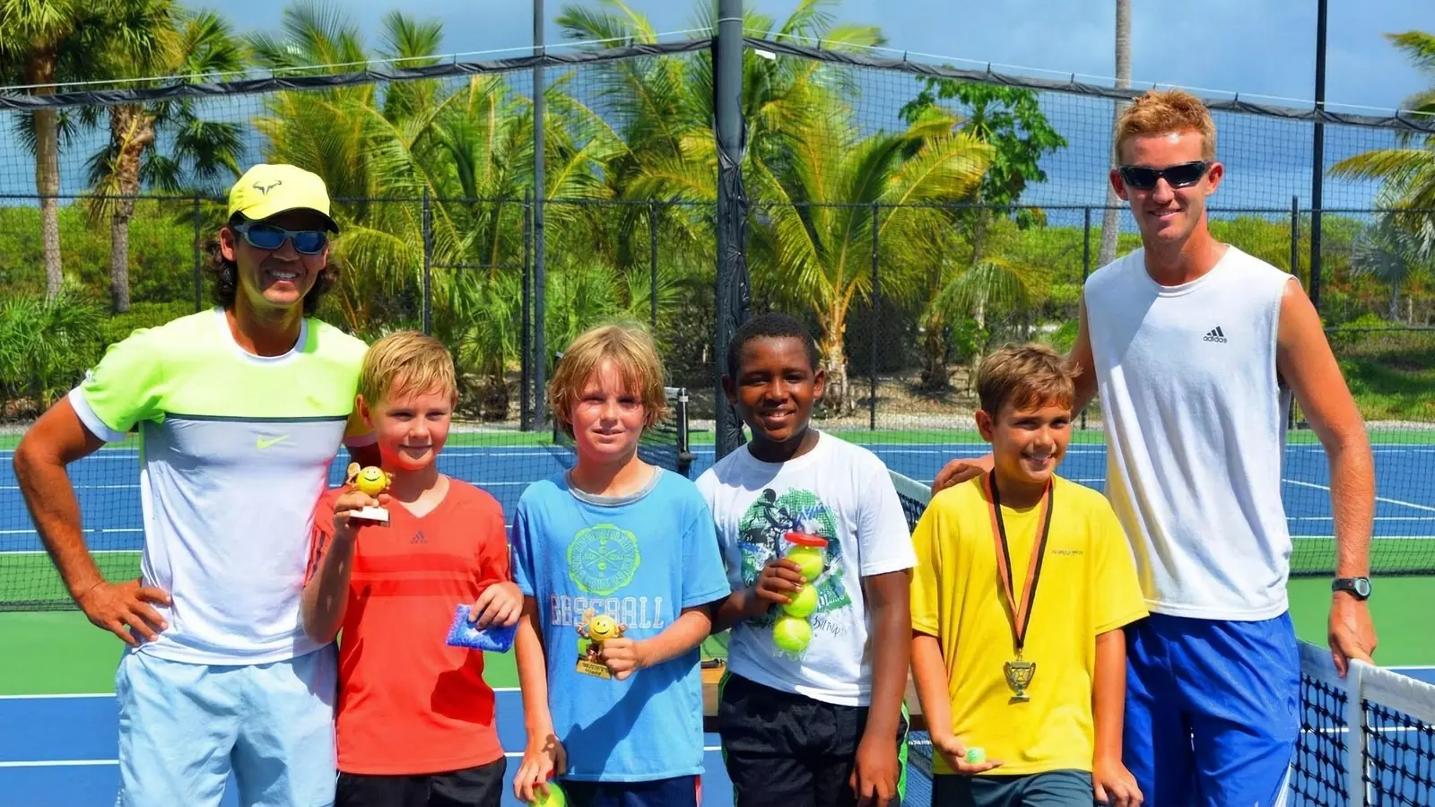 Coaches and junior academy players with their trophies